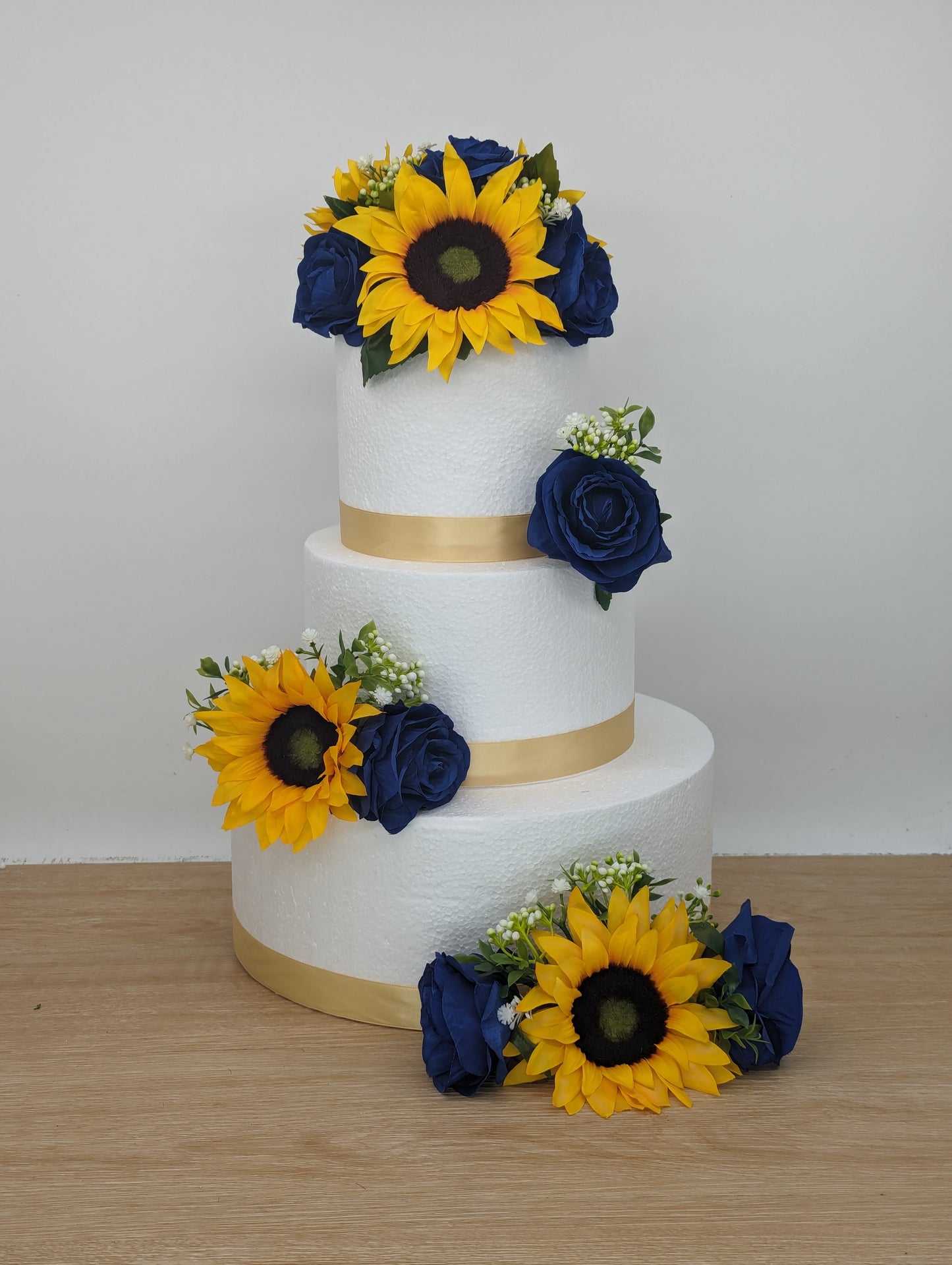 Sunflower, blue rose and foliage cake flowers and topper.