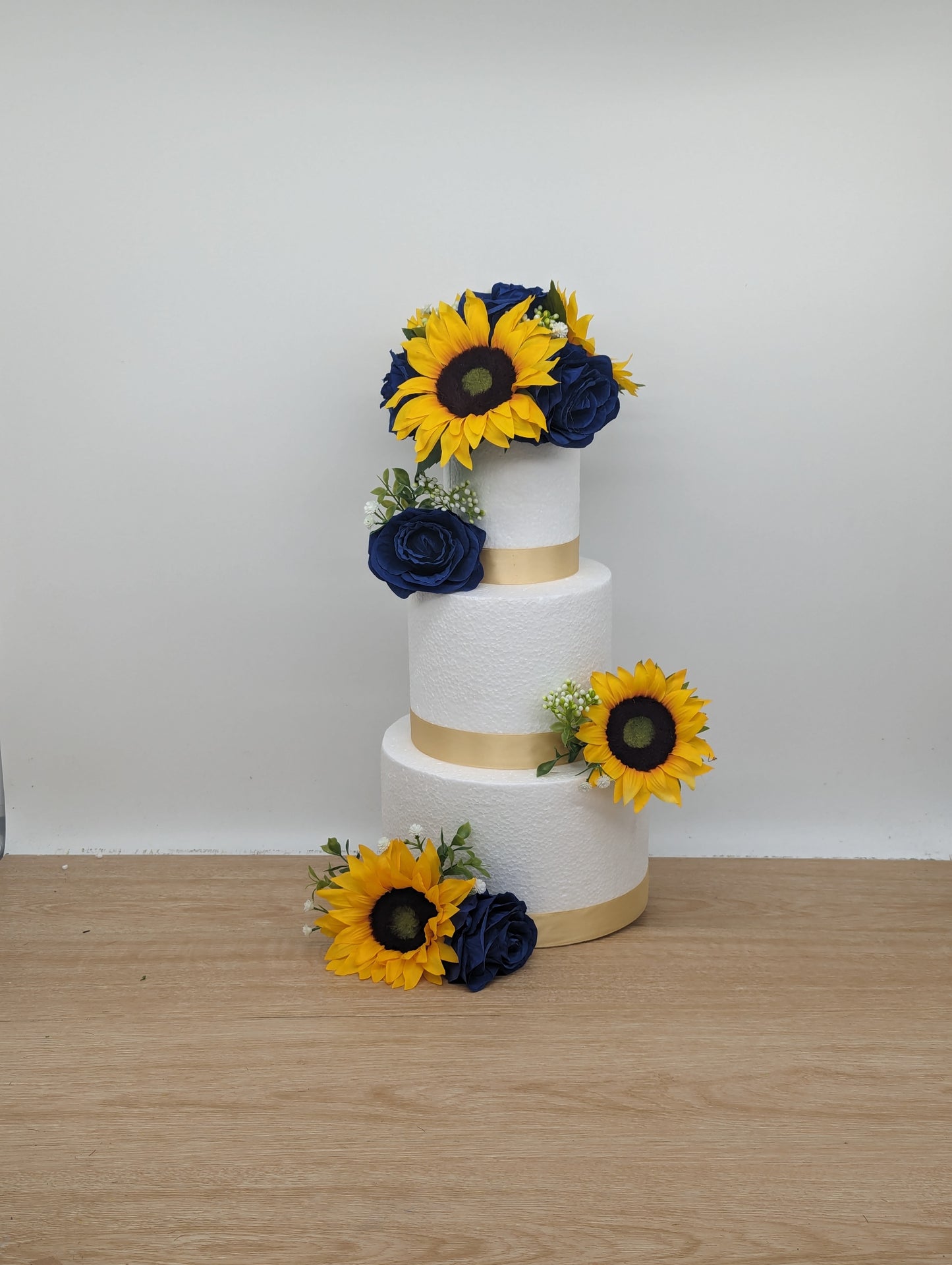 Sunflower, blue rose and foliage cake flowers and topper.