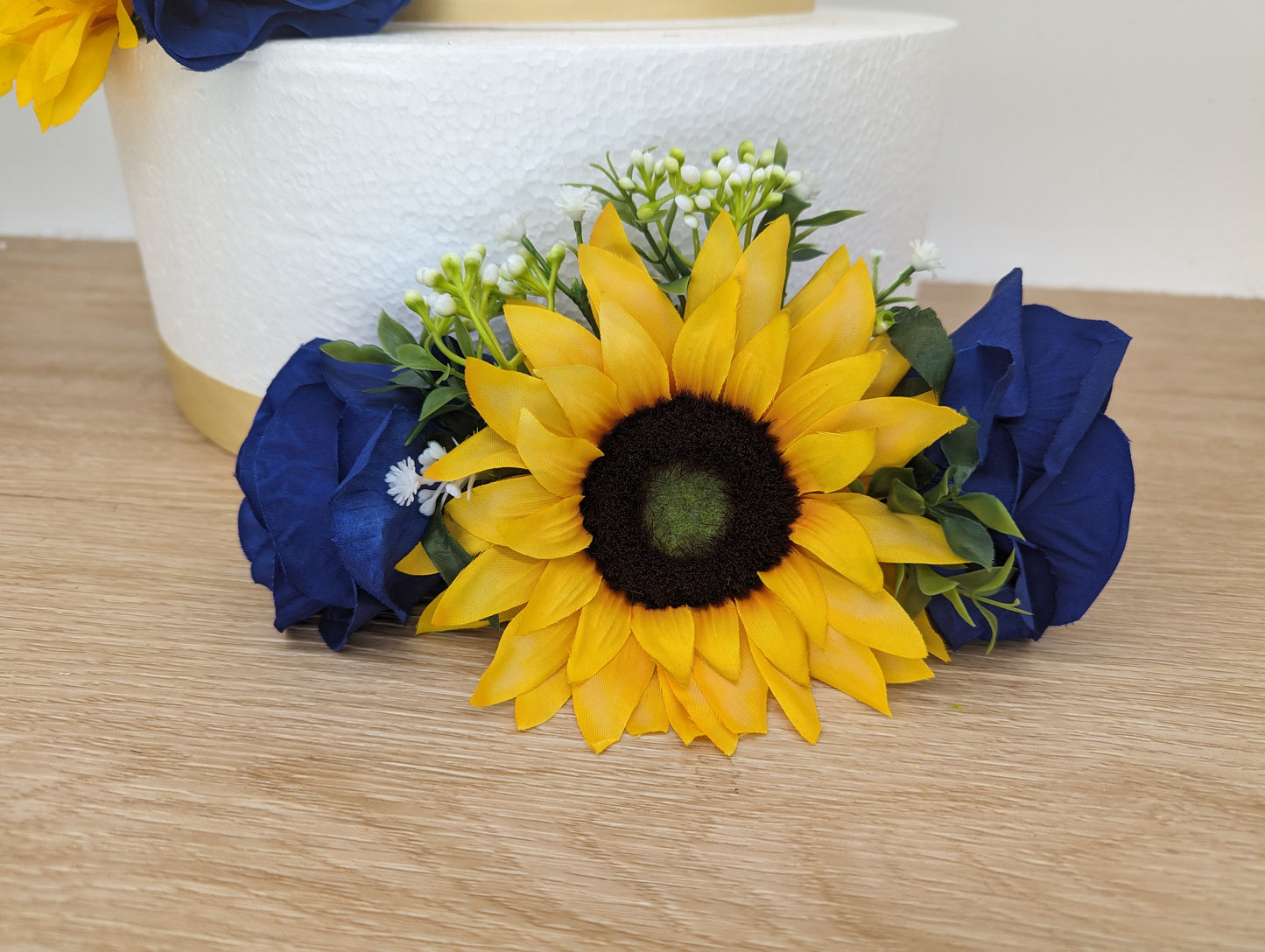 Sunflower, blue rose and foliage cake flowers and topper.