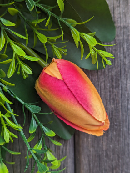 Artificial yellow and orange tulip door swag with tealeaf foliage finished with a hessian bow.